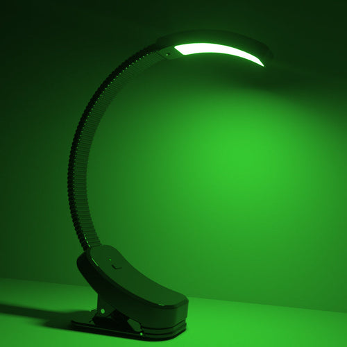 Verdant Light clip-on lamp glowing green on a desk